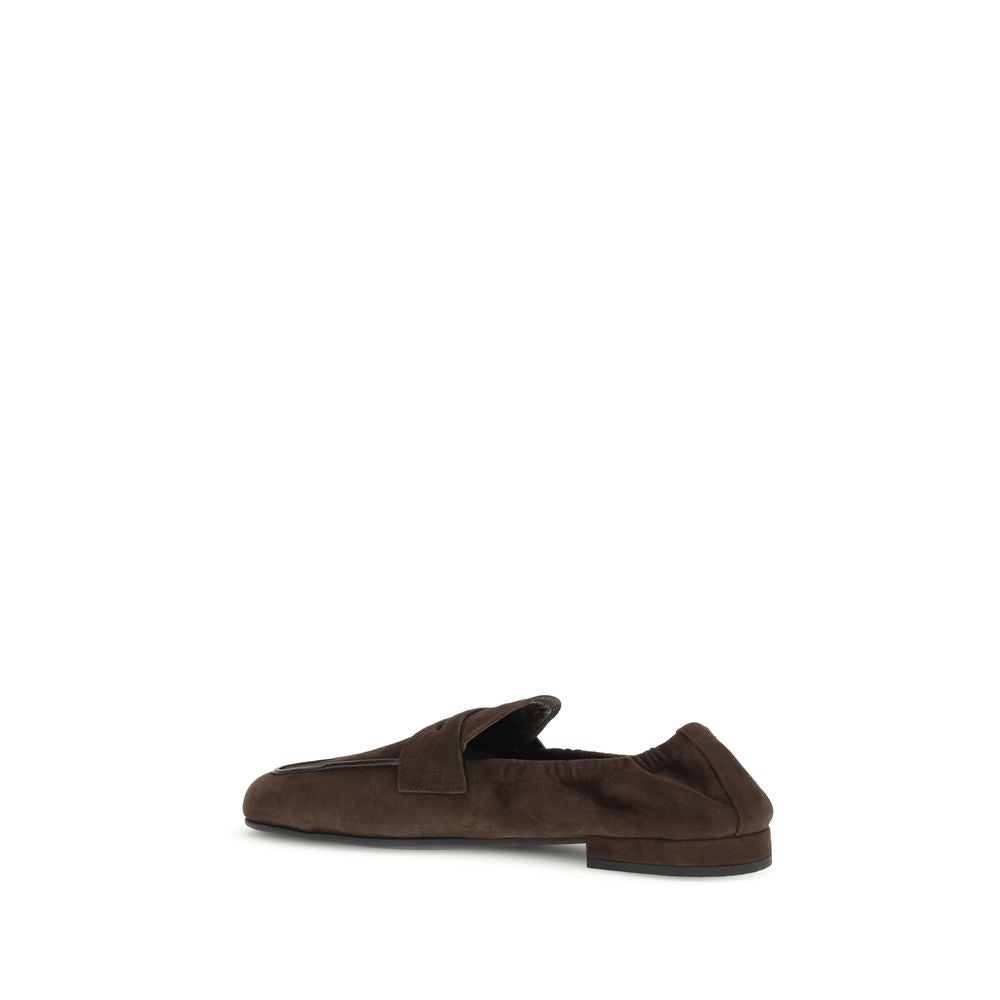 Prada Brown Lamb Ovis Aries Aries Slip-On Loafers with leather horsebit upper and rubber sole, side view.