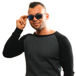 Man wearing SKECHERS MOD. SE6130 6220Q sunglasses, smiling in a black and grey sweater.