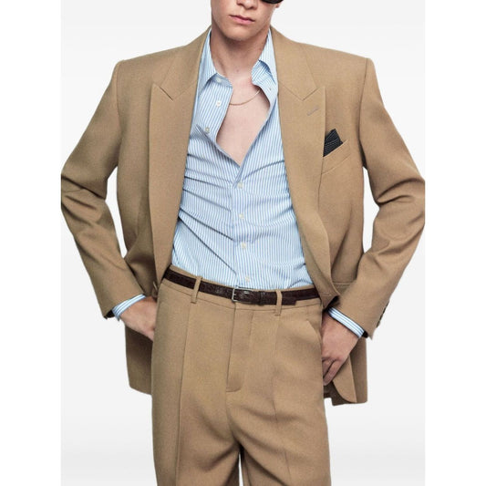 Model wearing Saint Laurent Jackets Beige wool single-breasted, front button jacket with chest and side welt pockets, true to size fit.