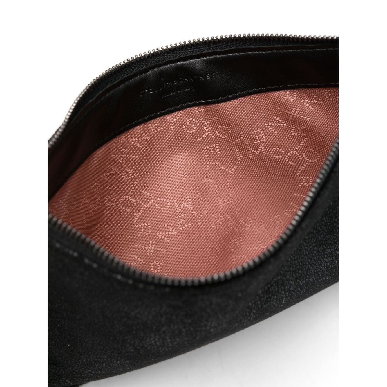 Interior view of Stella McCartney Falabella clutch in black faux suede with logo-jacquard lining and branded zip puller.