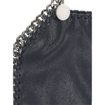 Close-up of chain-link trim on Stella McCartney Falabella mini handbag in blue black with designer tag visible.