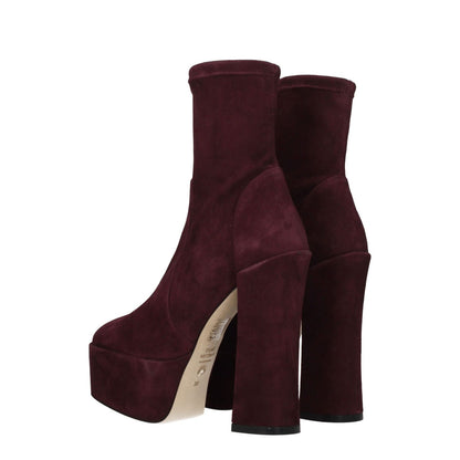 Stuart Weitzman Purple Leather Ankle Boots with round toe and high heel, made of suede with leather sole, shown in cordovan color.