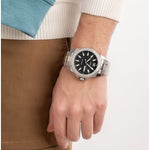 Gent's wrist with TIMEX Mod. ESSEX AVENUE watch, stainless steel bracelet, showing day and date on black dial.