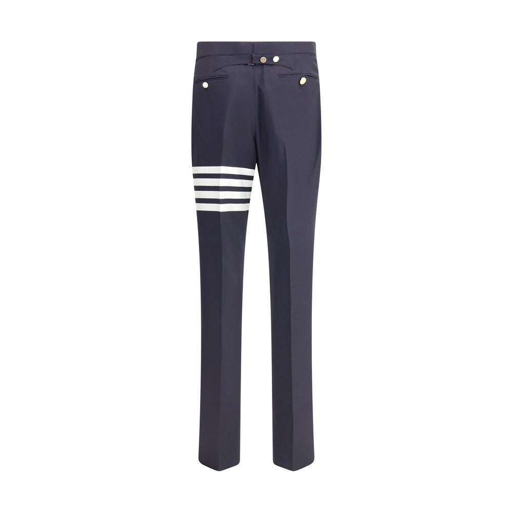 Thom Browne Blue Wool Dress Pants with contrasting buttons and iconic left leg bands, showcasing refined elegance for formal wear.