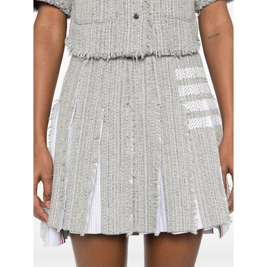 Medium grey cotton blend skirt featuring side button and zip fastening, frayed edges, and signature 4-Bar stripe by Thom Browne Skirts Grey.