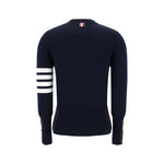 Back view of Thom Browne Virgin wool Sweater showcasing iconic horizontal bands and ribbed cuffs in navy blue.