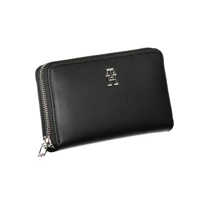 Tommy Hilfiger Black Polyester Wallet with zip closure, logo, and 5 compartments including coin purse and card slots made of recycled polyester.