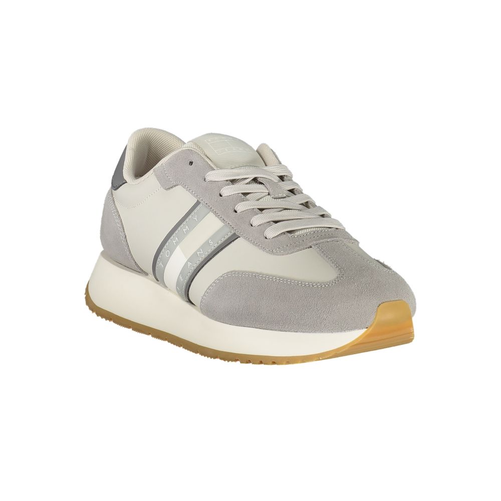 Stylish sporty men's sneaker in gray with leather and textile materials, featuring a gum sole and white stripe accents.