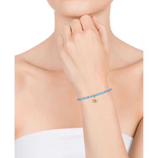 Woman wearing VICEROY JEWELS Mod. 13145P100-43 silver 925° bracelet with blue stones and golden charm, elegant and stylish accessory.