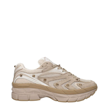 Valentino Garavani Beige Fabric Low Top Sneakers with front and back logos, studs, lace-up closure, and round toe design.