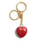 Valentino Garavani Coeur Royal key ring featuring a red heart charm with logo, polished finish, gold rings; size: 13 cm length, 3.5 cm width.