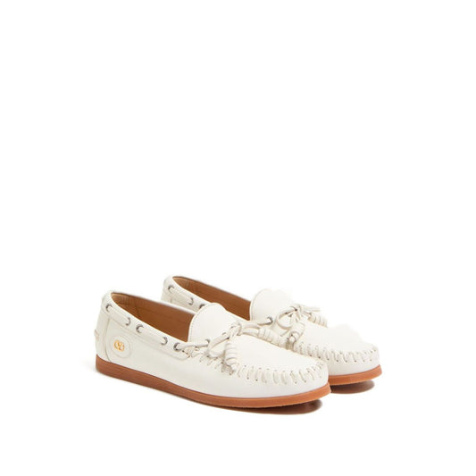 Valentino Garavani Palm Avenue Buffalo Boat Shoe, white slip-on with VLogo Signature bow, flat rubber sole.