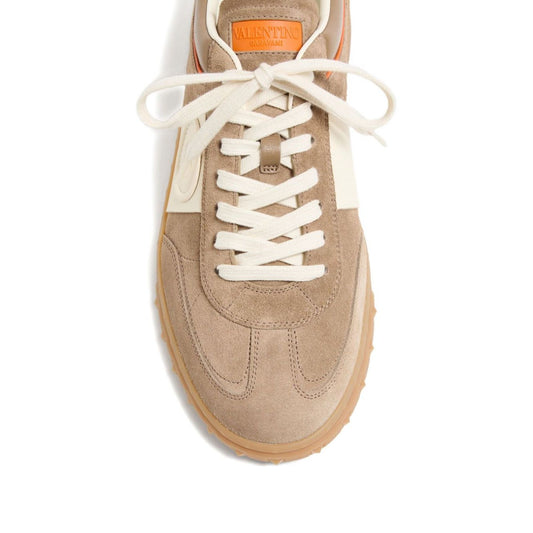 Valentino Garavani Upvillage Crust Leather Sneaker in caramel brown with panelled design, rubber sole, lace-up fastening, and logo detail.
