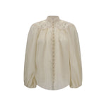 Zimmermann Embroidered Coco Blouse featuring puff sleeves and lace details.